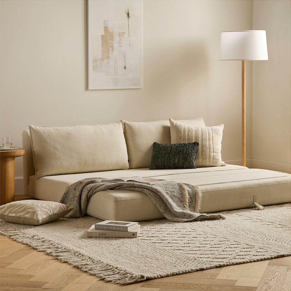 Sofa giường phong cách ven biển màu trắng cổ điển, khung gỗ chắc chắn, dễ dàng mở thành giường ngủ.